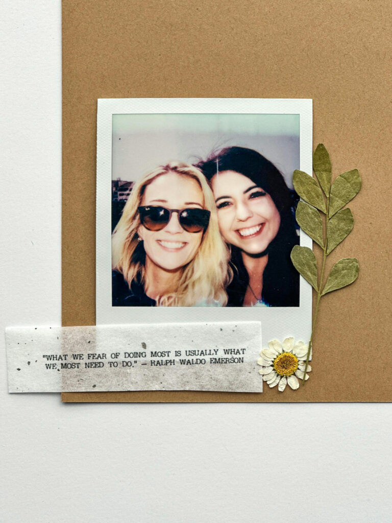 A Polaroid photo of two smiling women on a vision board, decorated with dried flowers and an inspiring quote. Vision Board for Galentine's Day